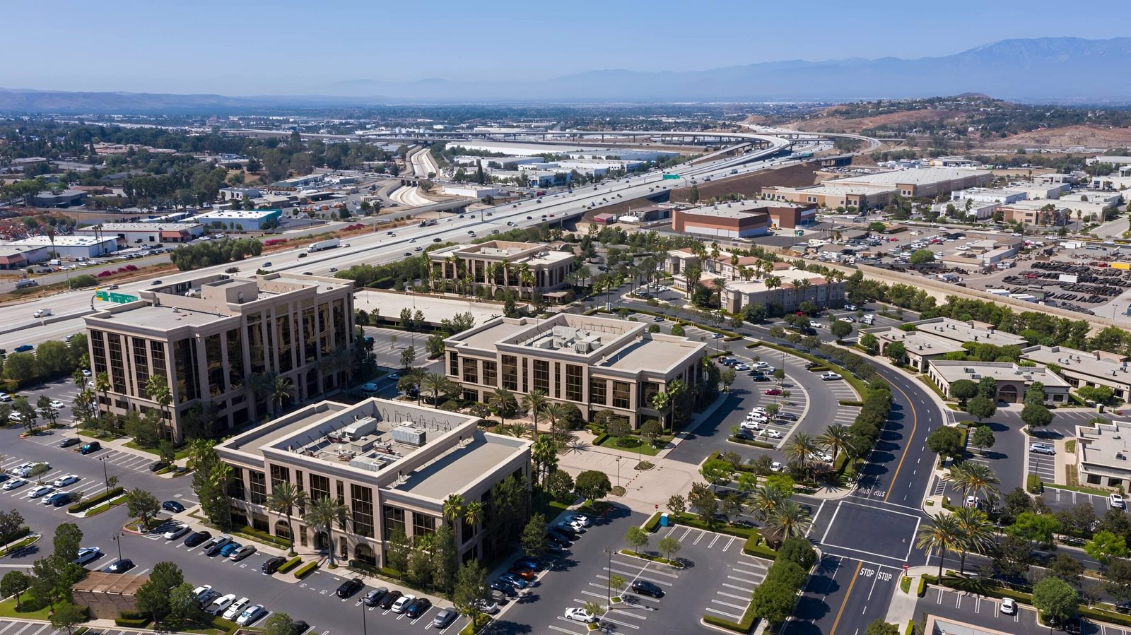 Aerial view of office buildings and parking lots.