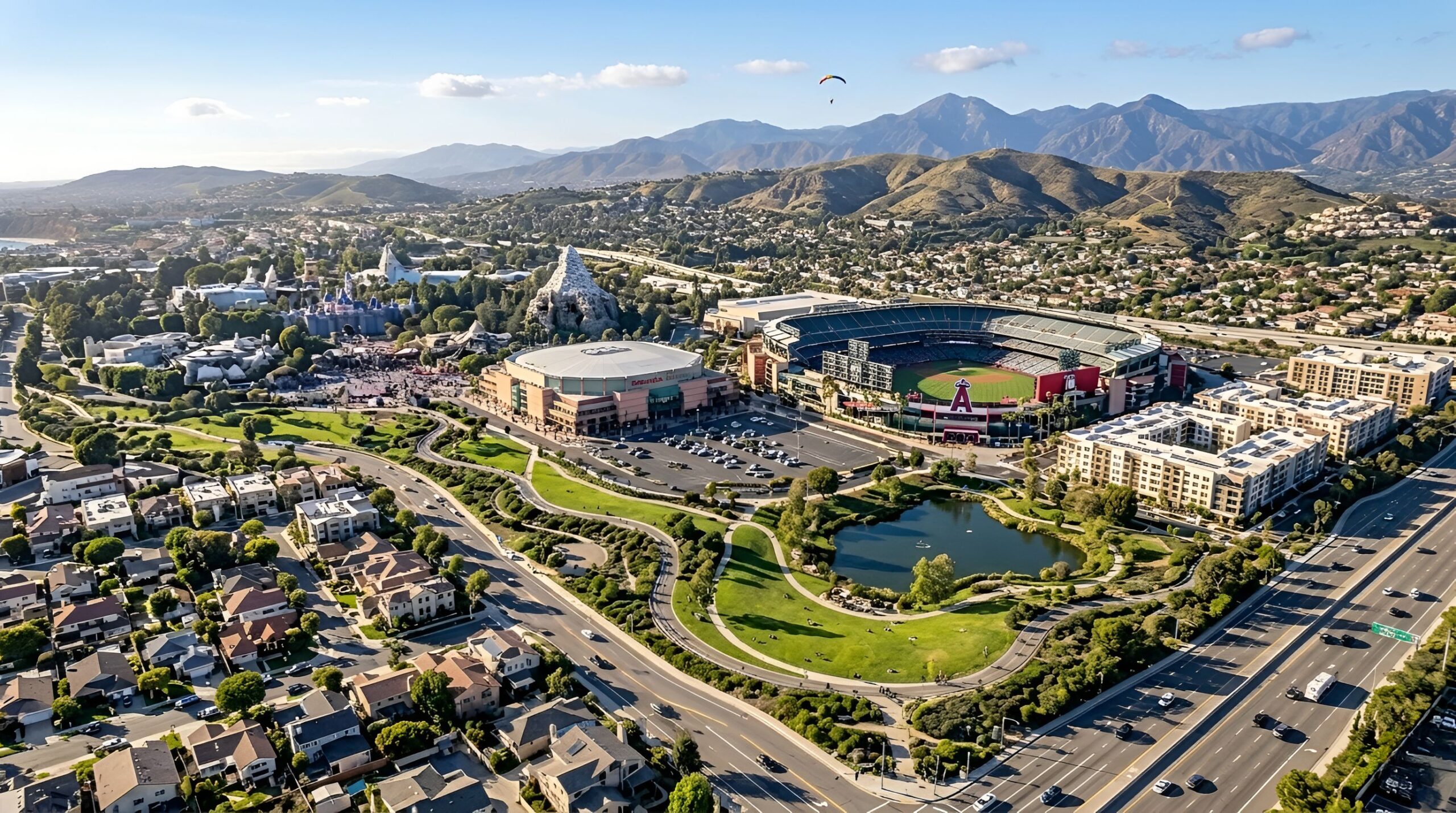 Aerial view of city, roads, and nearby hills.