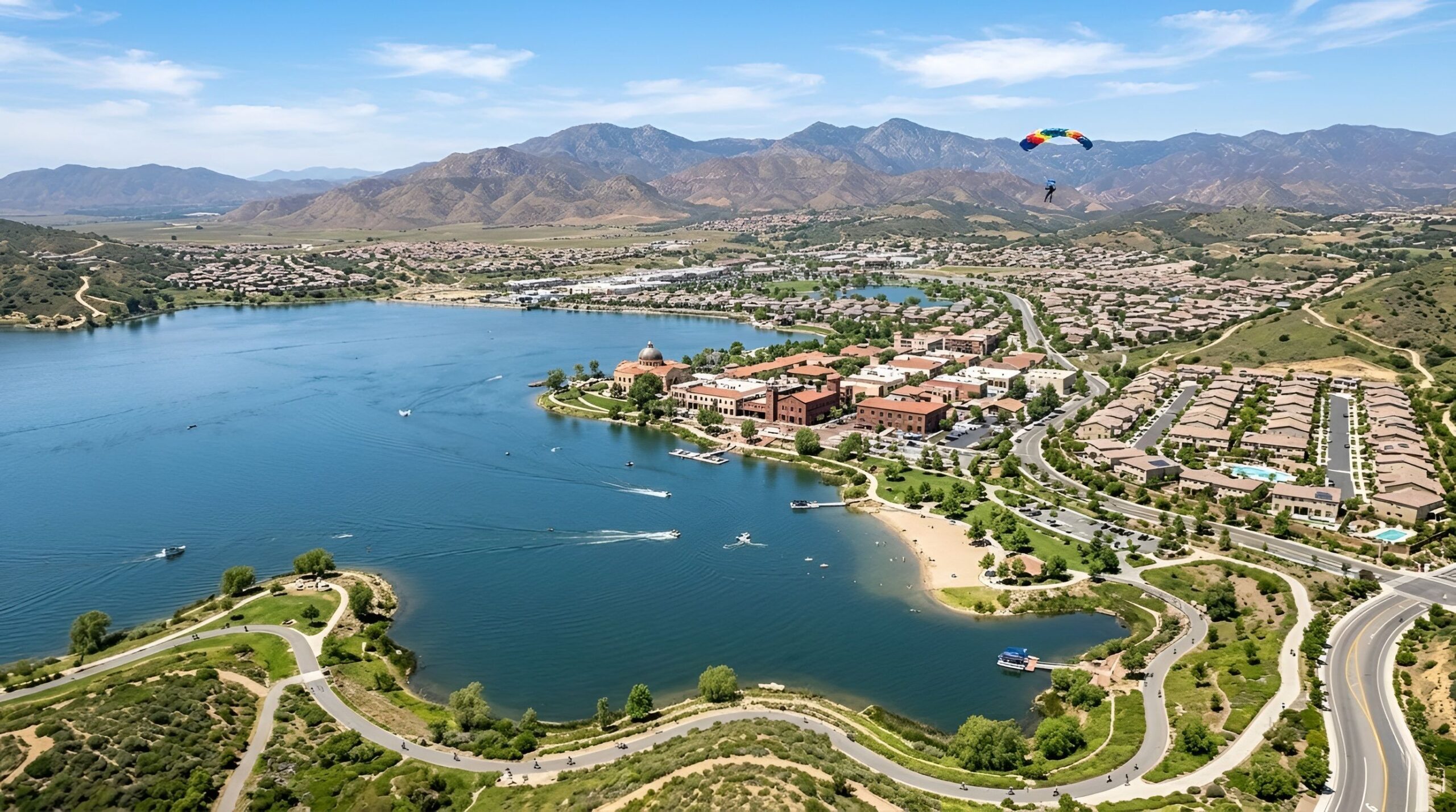 Lakefront neighborhood with homes and mountain views.